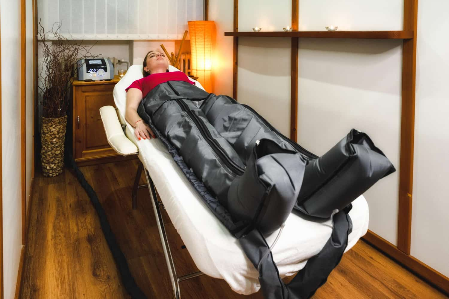 Compression Therapy: Benefits, Uses, Risks & Who Needs It - Woman wearing compression stockings to improve circulation and reduce swelling in legs.